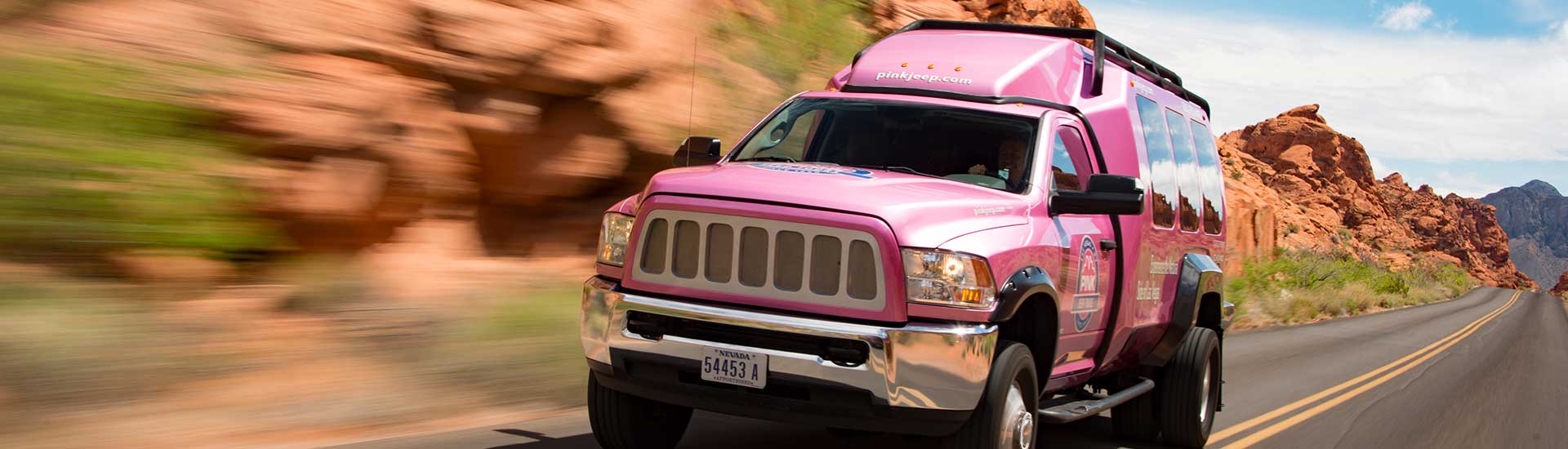 Motion image of Pink Jeep Tour Trekker driving through Valley of Fire State Park, Nevada.