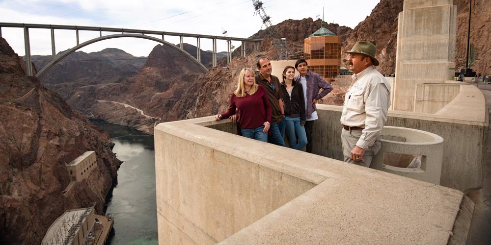 Pink Adventure Tours guide and guests on the Observation Deck overlooking Hoover Dam in Las Vegas.