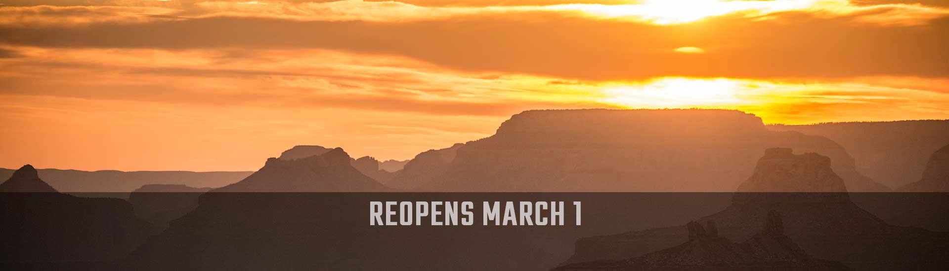 Golden sun sets behind the jagged South Rim of the Grand Canyon, Hermits Rest Hike & Jeep Sunset Tour reopens March 1 banner.