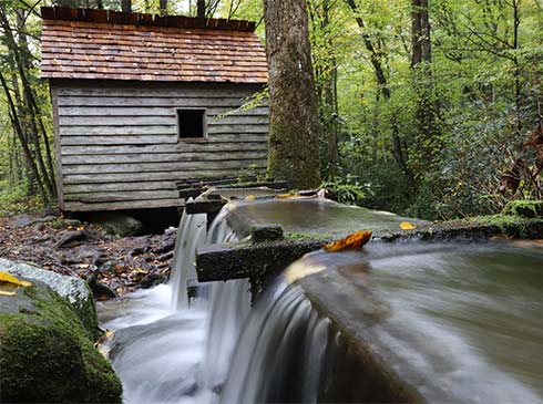 Grist mill with rushing water shute, located along the Roaring Fork Motor Nature Trail, in Great Smoky Mountains National Park.