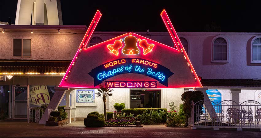 Nighttime view of the World Famous Chapel of the Bells Wedding on the Las Vegas Strip lit up in neon lights, Pink Jeep Las Vegas Bright Lights Tour.