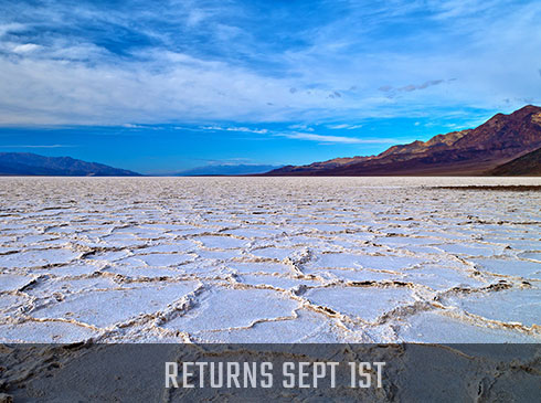 Death Valley image of white salt flats with Pink Jeep Tours Returns SEPT 1st banner.