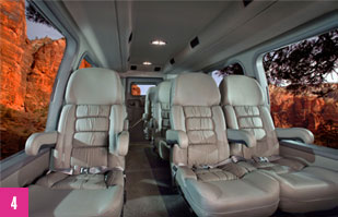 Interior image of the large, leather captain's chairs inside a Pink® Adventure Tour Trekker.