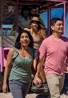 Guests on the Grand Canyon Hermit's Rest Hike & Jeep tour exiting the rear of a custom Pink® Jeep® vehicle.