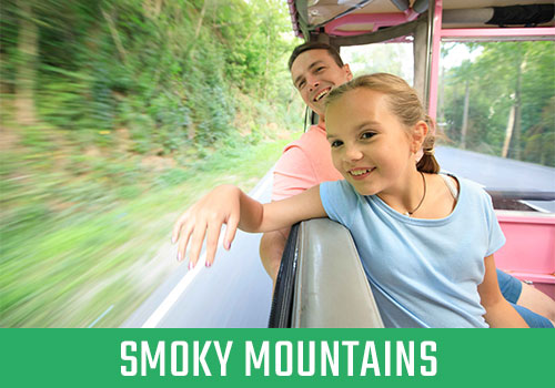 Father and daughter riding in Jeep, smiling. Text overlay says "Smoky Mountains"