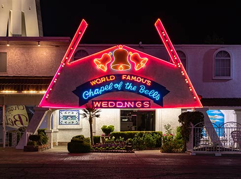 World Famous Chapel of the Bells Wedding venue on the Las Vegas Strip is lit up with neon lights after dark.