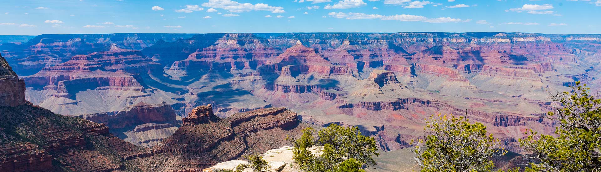 View of the Grand Canyon South Rim on a beautiful summer day with blue sky and puffy white clouds, Grand Canyon National Park, USA.