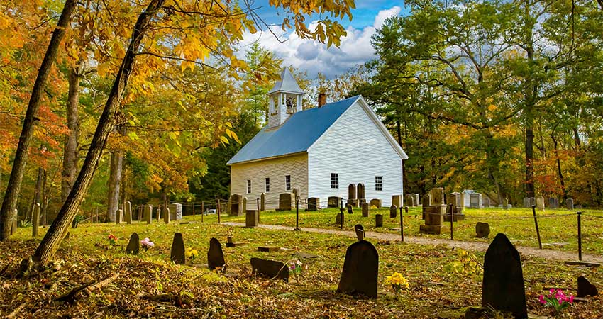 Autumn landscape of the restored Primitive Baptist Church and graveyard on the Cades Cove Loop Road, GSMNP in Tennessee.