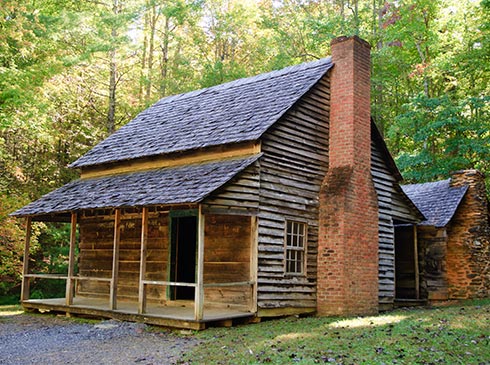 Historic cabin with stone chimney in Cades Cove, in the Great Smoky Mountains National Park, TN.