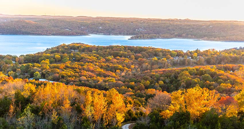 Aerial view of autumn trees surrounding Table Rock Lake from Pink Jeep Tours exclusive viewpoint atop Baird Mountain, Branson, MO.