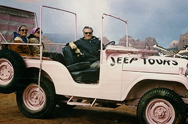 Guide giving a tour  in a Pink Jeep for Pink Adventure Tours back in 1960.