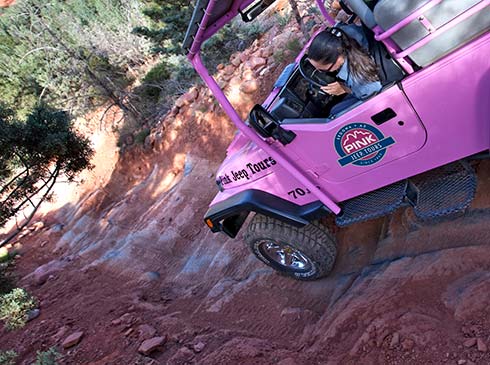 Closeup of a Pink Jeep Adventure Guide navigating the steep descent on the Road-of-No-Return stone staircase, Sedona, AZ,