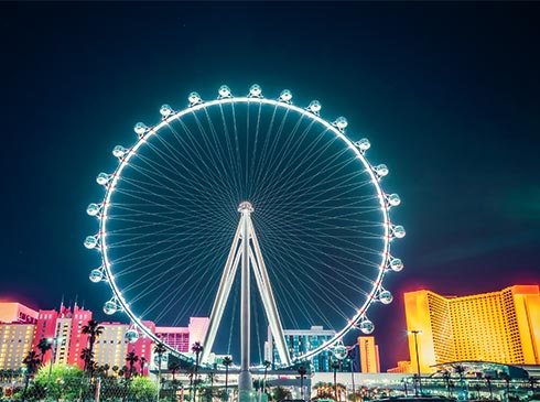 The Las Vegas High Roller, the world's second tallest observation wheel, glows in neon lights and rises 550-feet above the Las Vegas Strip.