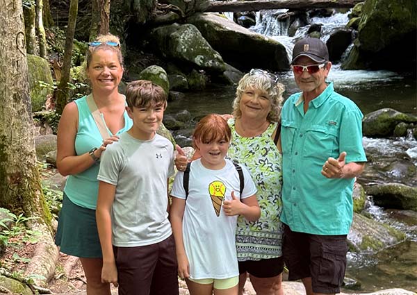 Mother, two kids and grandparents pose in front of the Roaring Fork Stream, along the Roaring Fork Motor Nature Trail, in the Great Smoky Mountains.
