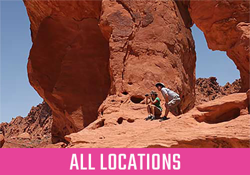 Tour guide and guest peering across Fire Valley State Park, Two Tour Discount