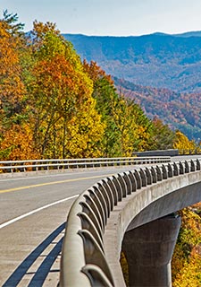 The missing link section of the Foothills Parkway winds through an autumn landscape in Great Smoky Mountains National Park.