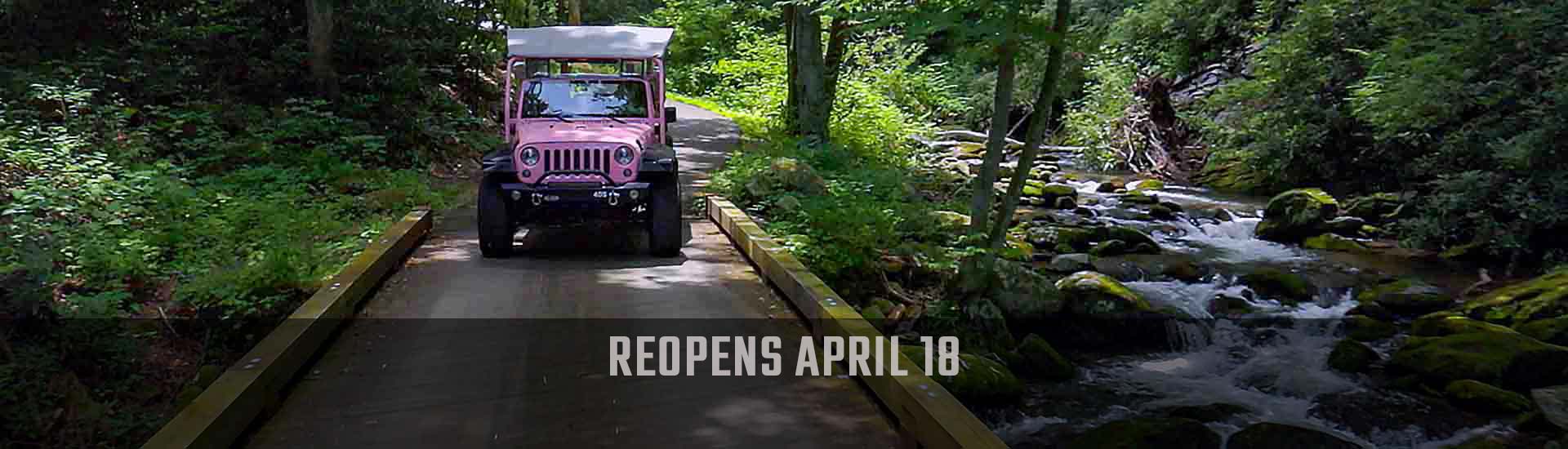 Pink Jeep Wrangler driving on the Roaring Fork Motor Nature Trail in Great Smoky Mountains National Park, with reopens April 18 banner.