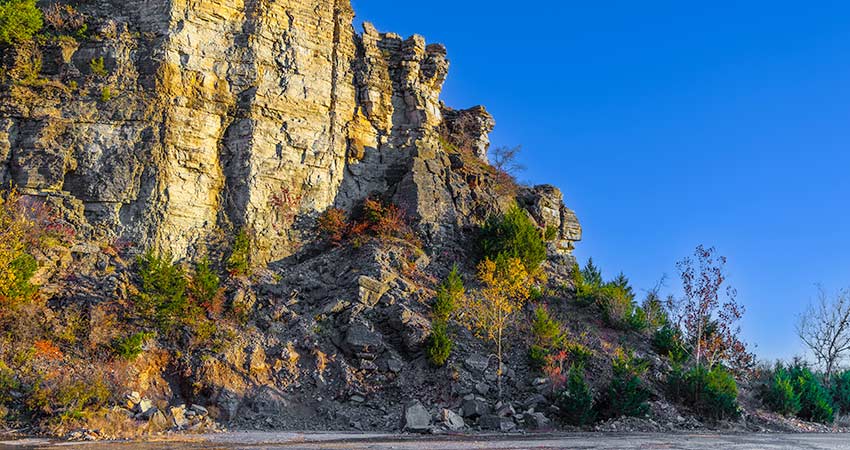 Beautiful autumn colored trees growing along the cliffside in the rock quarry at the base of Baird Mountain in Branson, Missouri.